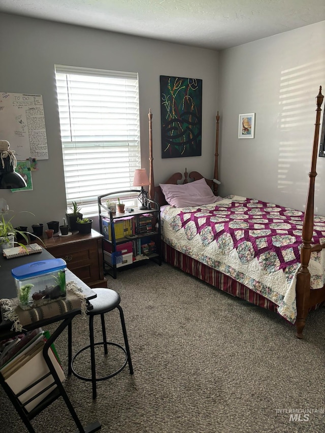 bedroom with carpet and a textured ceiling