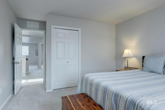 bedroom with baseboards, carpet, a closet, and visible vents