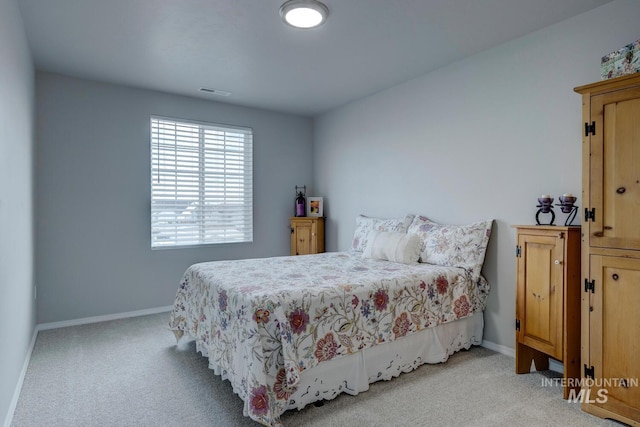 bedroom featuring baseboards, carpet floors, and visible vents