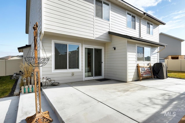 back of house with fence and a patio area