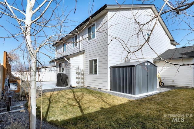 back of property featuring an outbuilding, a shed, fence, a patio, and a yard