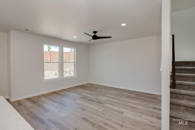 empty room featuring ceiling fan and light hardwood / wood-style floors