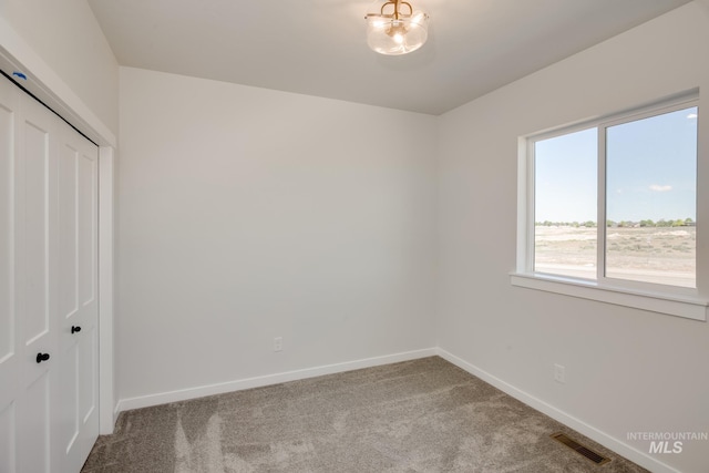 unfurnished bedroom with carpet flooring and a closet