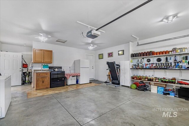 1128 W Wirsching Ave, Twin Falls, ID 83301 - garage featuring freestanding refrigerator, a garage door opener, and ceiling fan