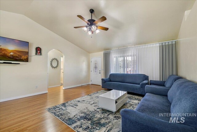 1128 W Wirsching Ave, Twin Falls, ID 83301 - living room featuring lofted ceiling, a ceiling fan, arched walkways, and wood finished floors