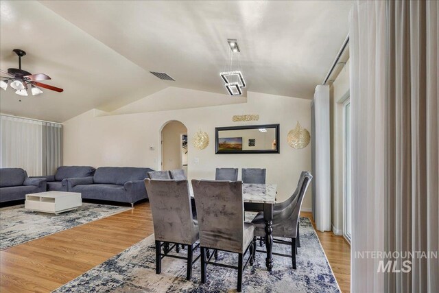 1128 W Wirsching Ave, Twin Falls, ID 83301 - dining space featuring arched walkways, vaulted ceiling, ceiling fan, and wood finished floors