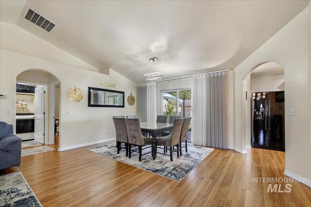 1128 W Wirsching Ave, Twin Falls, ID 83301 - dining room featuring arched walkways, vaulted ceiling, and light wood-type flooring