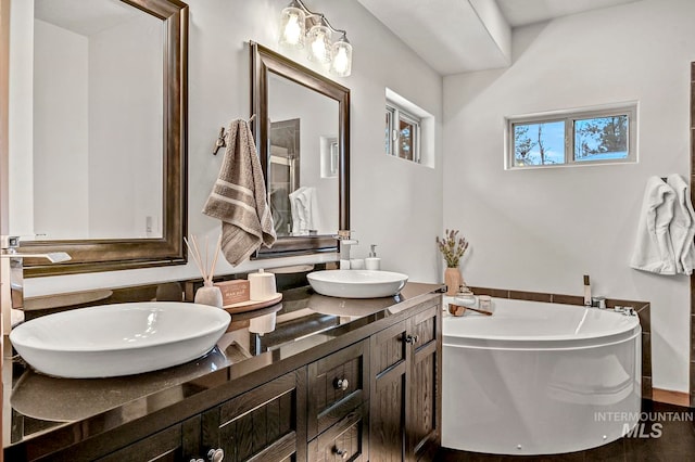 bathroom with vanity and a bathtub