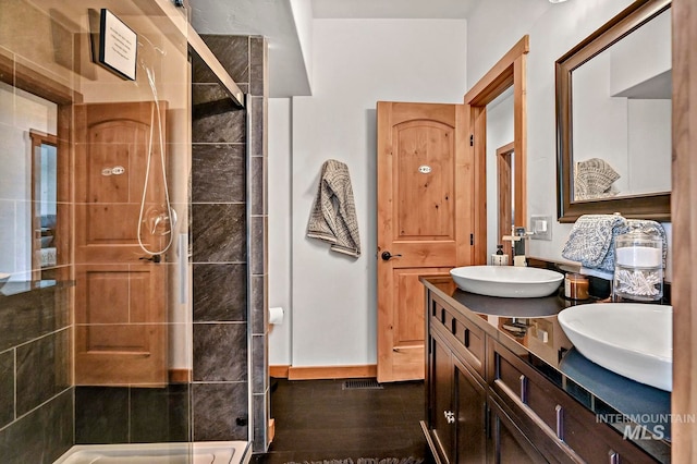 bathroom featuring vanity and a tile shower