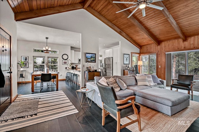 living room with dark wood-type flooring, high vaulted ceiling, ceiling fan with notable chandelier, beam ceiling, and wood ceiling