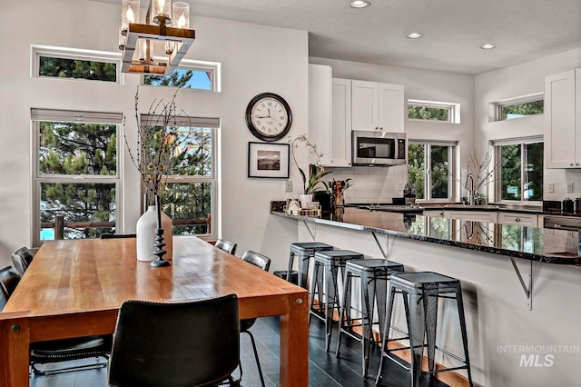 dining room with sink and a notable chandelier