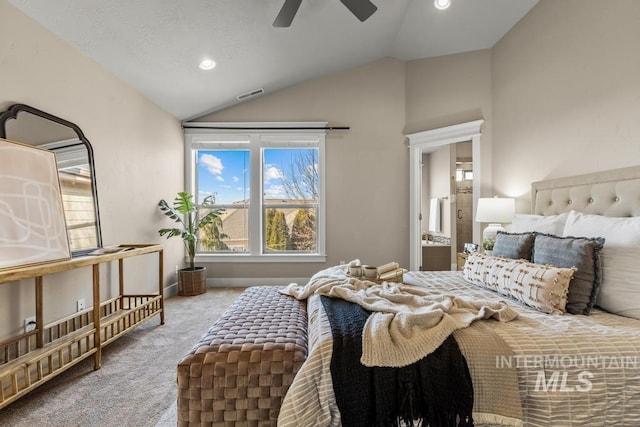 bedroom with light colored carpet, vaulted ceiling, ceiling fan, and ensuite bathroom