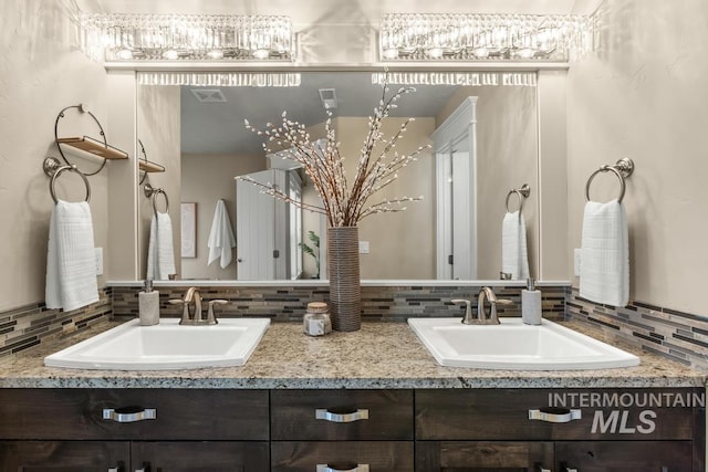 bathroom featuring decorative backsplash and vanity