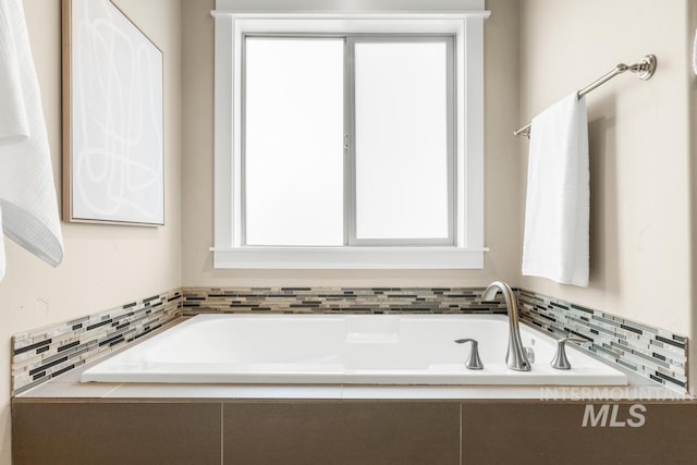 bathroom with tiled tub