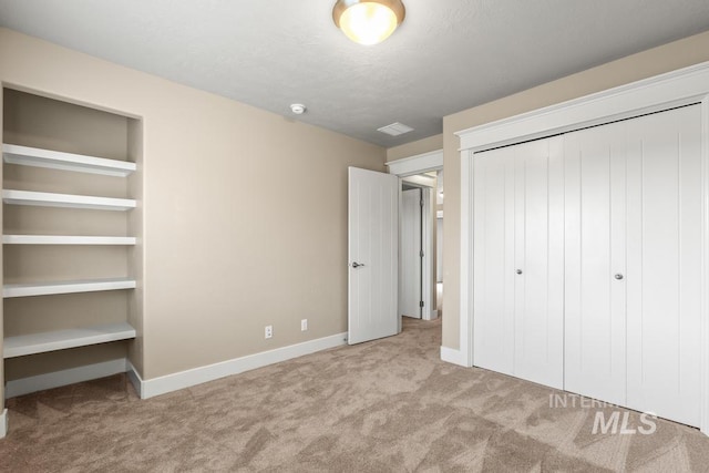 unfurnished bedroom featuring light colored carpet