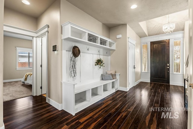 mudroom featuring dark hardwood / wood-style flooring and a chandelier