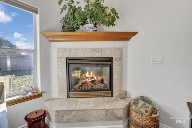 room details with a tiled fireplace and a textured wall