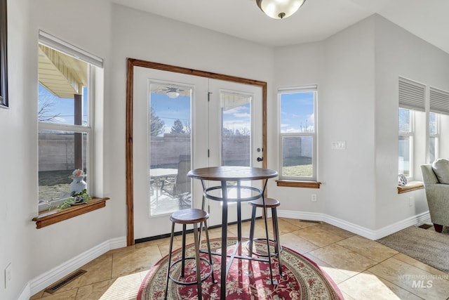 dining room featuring a healthy amount of sunlight, visible vents, and baseboards