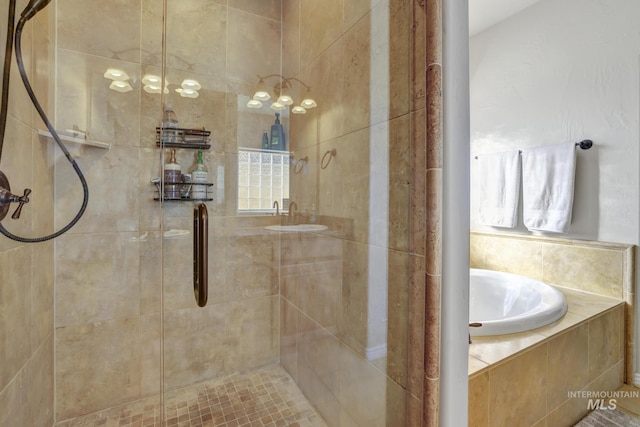 full bathroom featuring a garden tub and a tile shower