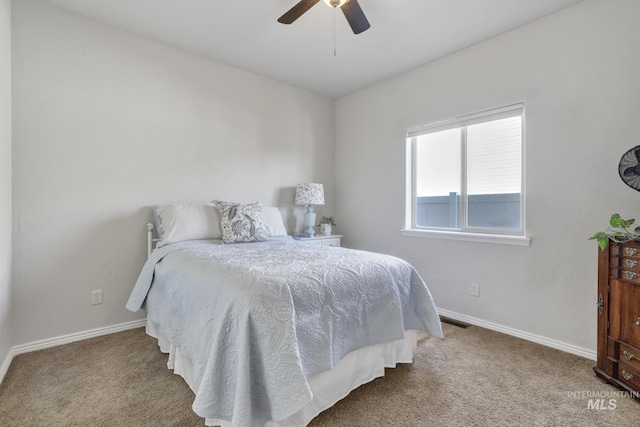 bedroom with visible vents, baseboards, carpet, and a ceiling fan