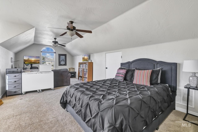 bedroom with carpet floors, a textured ceiling, lofted ceiling, and ceiling fan