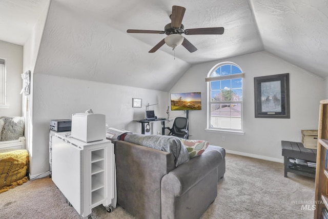 carpeted living room featuring baseboards, ceiling fan, a textured ceiling, and lofted ceiling