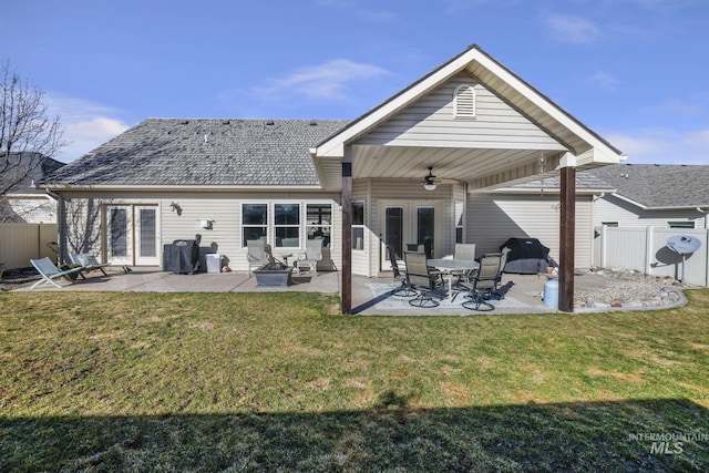 rear view of house with a patio, a lawn, a ceiling fan, and fence