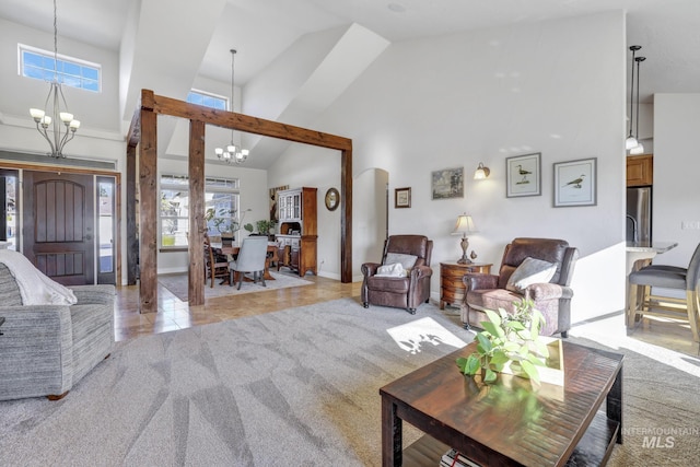 living room featuring light tile patterned floors, high vaulted ceiling, arched walkways, light carpet, and a notable chandelier