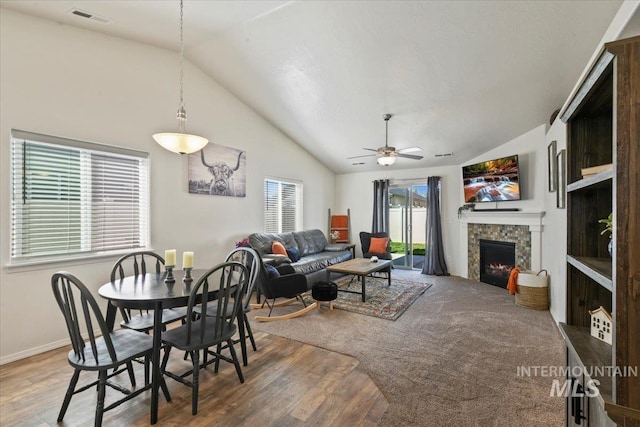 5416 Junegrass Way, Caldwell, ID 83607 - dining area with lofted ceiling, a ceiling fan, wood finished floors, a fireplace, and baseboards