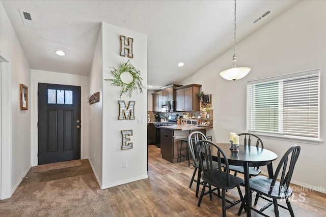 5416 Junegrass Way, Caldwell, ID 83607 - dining space with vaulted ceiling, baseboards, recessed lighting, and wood finished floors