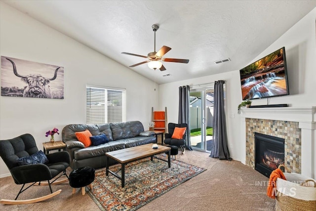 5416 Junegrass Way, Caldwell, ID 83607 - living room with carpet, lofted ceiling, ceiling fan, a tiled fireplace, and a textured ceiling