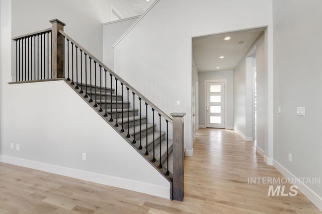 stairs featuring baseboards, recessed lighting, and wood finished floors
