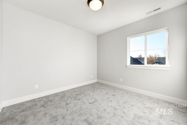 unfurnished room with visible vents, carpet, and baseboards