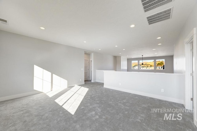 carpeted empty room featuring visible vents, recessed lighting, and baseboards