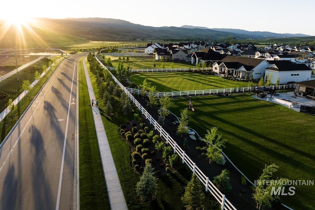 view of community featuring fence, a mountain view, and a residential view
