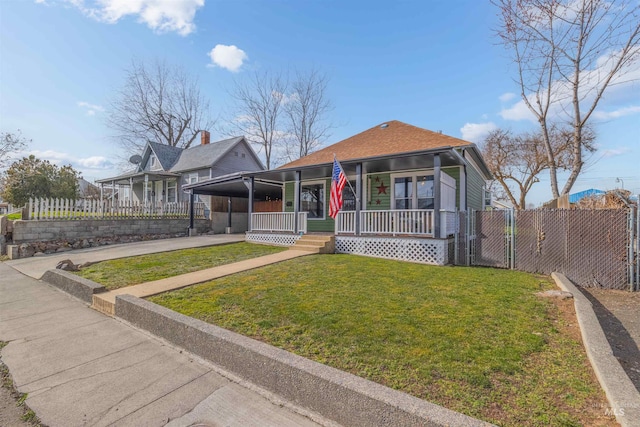 view of front of house featuring a porch, fence, concrete driveway, a carport, and a front lawn