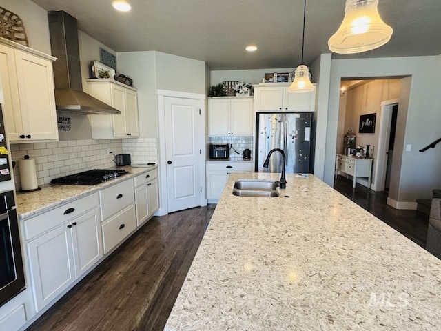 805 Drayton Ave, Twin Falls, ID 83301 - kitchen with wall chimney range hood, freestanding refrigerator, a sink, oven, and dark wood-type flooring