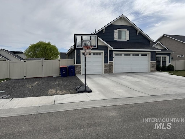 805 Drayton Ave, Twin Falls, ID 83301 - view of front of home featuring a gate, stone siding, an attached garage, and driveway