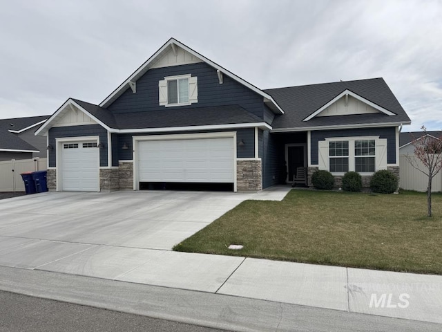 805 Drayton Ave, Twin Falls, ID 83301 - craftsman house with stone siding, driveway, board and batten siding, an attached garage, and a garage