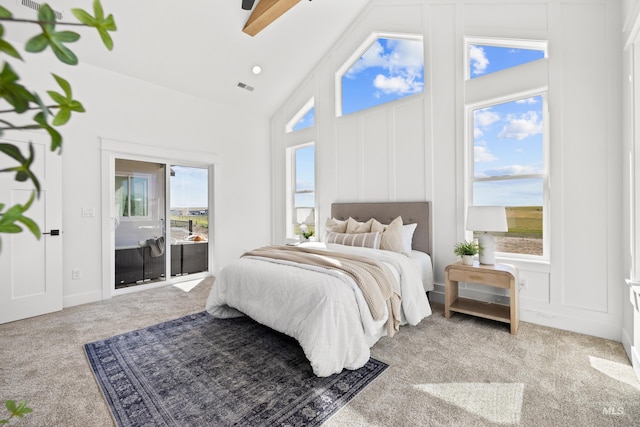 carpeted bedroom featuring multiple windows, ceiling fan, high vaulted ceiling, and access to exterior