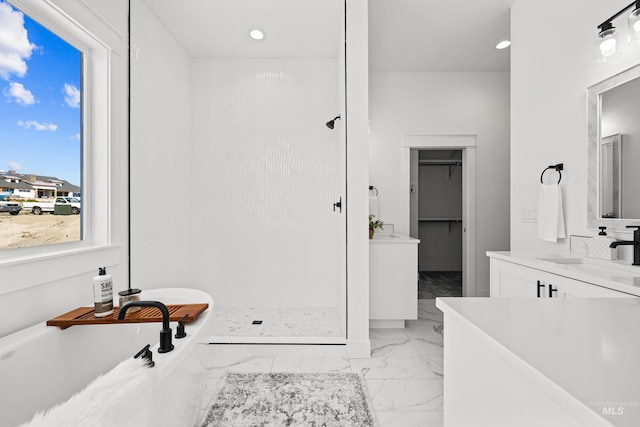 bathroom featuring plus walk in shower and vanity