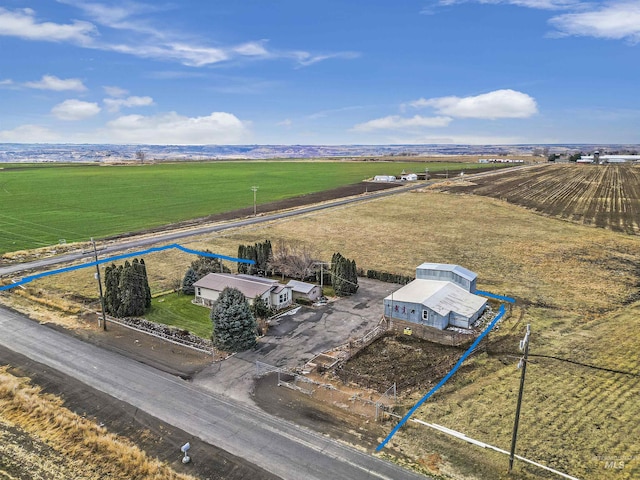 birds eye view of property with a rural view