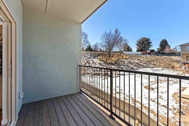 view of snow covered back of property