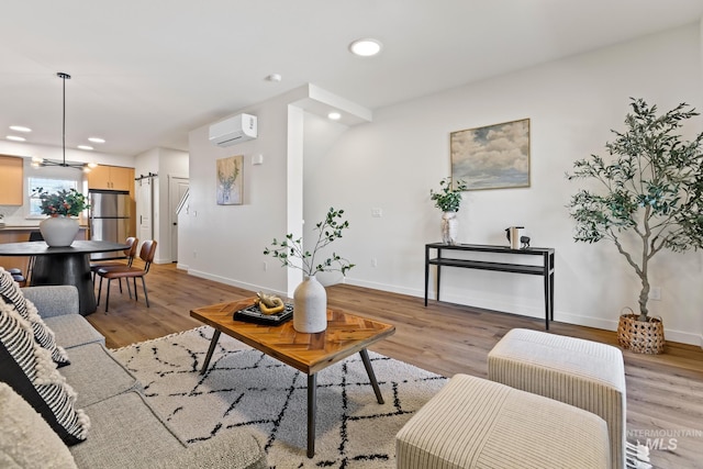 living room with light wood-style floors, baseboards, recessed lighting, and an AC wall unit
