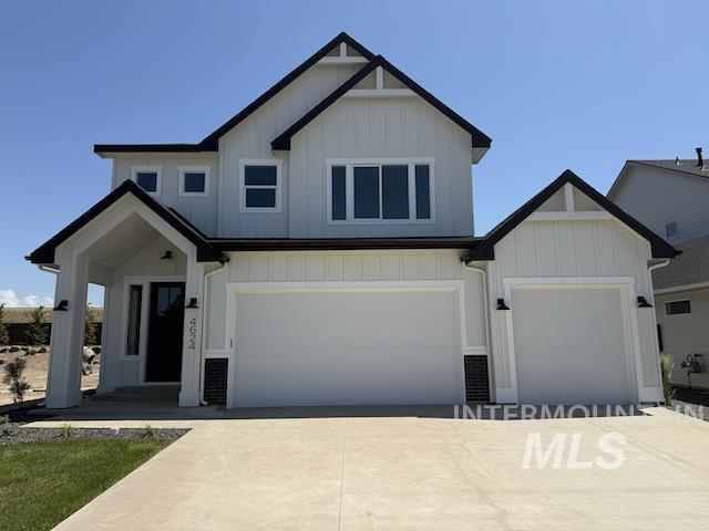 4624 N Alameda Creek Ave, Meridian, ID 83646 - modern farmhouse with concrete driveway, board and batten siding, and an attached garage
