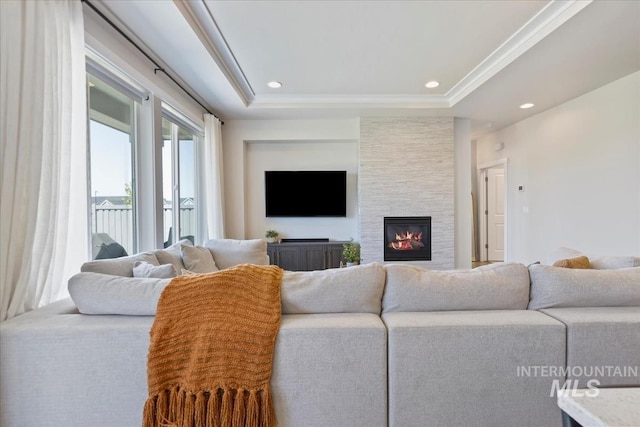 18245 N Arch Haven Way, Nampa, ID 83687 - living room featuring a large fireplace, a raised ceiling, and recessed lighting