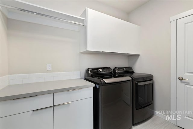 18245 N Arch Haven Way, Nampa, ID 83687 - clothes washing area featuring cabinet space, washer and dryer, and baseboards