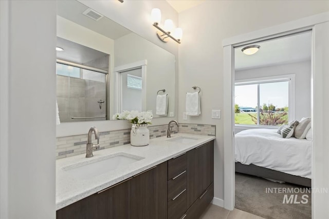 18245 N Arch Haven Way, Nampa, ID 83687 - full bathroom featuring a stall shower, backsplash, double vanity, and connected bathroom