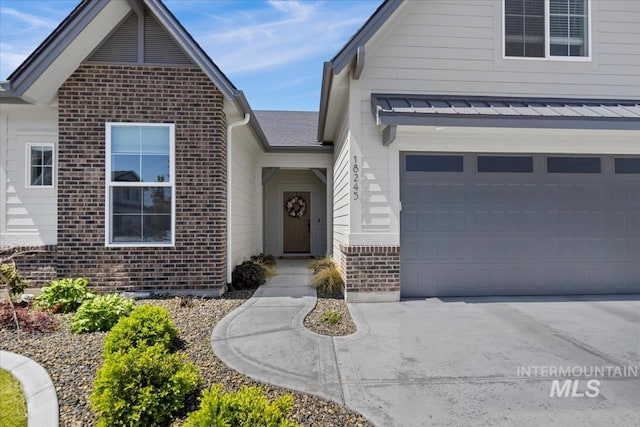 18245 N Arch Haven Way, Nampa, ID 83687 - view of front facade with brick siding, concrete driveway, and a garage