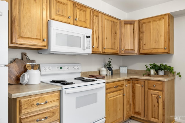 8305 W Rifleman St, Boise, ID 83704 - kitchen with white appliances, light countertops, and brown cabinets
